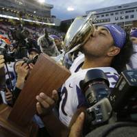 Washington’s Vita Vea kisses the Apple Cup trophy after the Huskies’ victory over the Cougars on Saturday in Pullman, Washington. No. 6 Huskies rout No. 23 Cougars in Apple Cup showdown