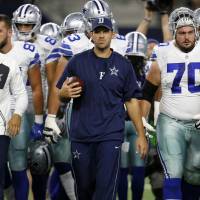 Dallas Cowboys QB Tony Romo (center) is running the scout team in practice even though he appears healthy after a back injury. Romo practicing, but playing status unclear
