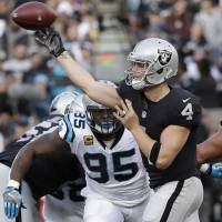 Raiders quarterback Derek Carr passes against the Panthers during the second half of his team’s win on Sunday in Oakland. Carr returns from injury to help Raiders rally past Panthers
