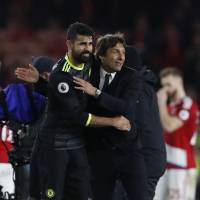 Chelsea striker Diego Costa gets a hug from manager Antonio Conte after their win on Sunday. Costa sends Chelsea into first place