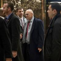 CKE Restaurants CEO Andrew Puzder (center) departs Trump Tower in New York Wednesday. Trump set to fill labor portfolio with fast-food exec who opposes unions, base pay hikes, Obamacare