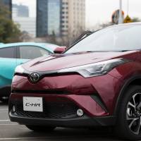 The Toyota C-HR gasoline model (right) and hybrid model SUVs are displayed in a parking lot during a media event ahead of the sales launch in Tokyo on Dec. 13. Toyota hybrid bet pays off as emissions scandal ignites demand in Europe