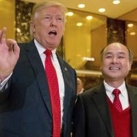 President-elect Donald Trump, accompanied by SoftBank CEO Masayoshi Son, speaks to members of the media Dec. 6 at Trump Tower in New York. Trump again takes credit for 8,000 jobs where credit is actually due Softbank's Son