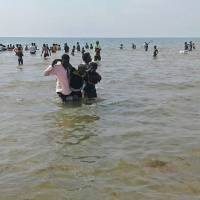 People help a man ashore from Lake Albert on Monday in Buliisa, after at least 30 Ugandan members of a village football team and their fans drowned when their boat capsized on Lake Albert during a party. Police officers working with local fishermen managed to rescue 15 of the revellers, who were heading from the village of Kaweibanda in the western Buliisa District to watch a friendly Christmas Day match in Hoima District, Rutagira said. At least 30 Uganda soccer players, fans drown as boat flips during Christmas party