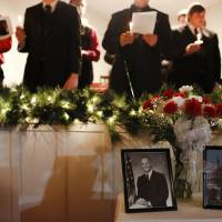 Portraits of John Glenn sit on a table as members of the Phi Mu Alpha Sinfonia at Muskingum University sing during a candlelight vigil to celebrate the life and legacy of Glenn at Westminster Presbyterian Church, where Glenn was a lifelong member, in New Concord, Ohio, Sunday. Glenn became a national hero in 1962 when he became the first American to orbit the Earth. He then spent 24 years as a Democrat from Ohio in the U.S. Senate. John Glenn's casket to lie in state longer than Lincoln's after Ohio capital processional