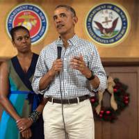 U.S. President Barack Obama addresses troops with first lady Michelle Obama at Marine Corps Base Hawaii in Kailua on Sunday. Obama says he could have cinched third term if allowed but Trump tweets otherwise