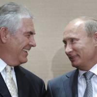 Russian Prime Minister Vladimir Putin (right) and Rex Tillerson, ExxonMobil’s chief executive, smile during a signing ceremony in the Black Sea resort of Sochi, Russia, in August 2011. President-elect Donald Trump selected Tillerson to lead the State Department on Monday. Trump selects Tillerson for State, dismissing Russia ties