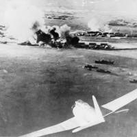 A Japanese bomber is seen in the foreground in a photograph taken by a Japanese pilot during the attack on Pearl Harbor, Hawaii, on Dec. 7, 1941. Abe's Pearl Harbor visit will do little to dispel theories persisting over the 1941 attack