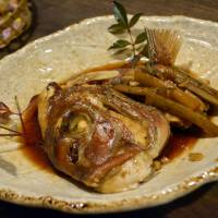A slow-cooked delicacy: A head of sea bream cooked in shoyu, sake and mirin (sweetened rice liquor) and served with burdock root. Wa Bistro Tsuna: Succulent fish heads along an old shopping street