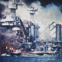 Survivor: A USS West Virginia crew member is rescued from the water after the bombing of Pearl Harbor, Hawaii, on Dec. 7, 1941. The mast of the USS Tennessee is beyond the burning West Virginia. Memories of 1941 Pearl Harbor attack continue to affect U.S., Japan in Asia