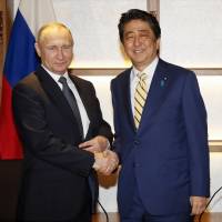 Smile now, cry later: Russian President Vladimir Putin shakes hands with Japanese Prime Minister Shinzo Abe during their December meeting in Nagato. Why Abe's Russian gambit is doomed