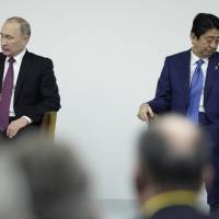 Hard talk: Russian President Vladimir Putin and Prime Minister Shinzo Abe attended the Japan-Russia Business Dialogue in Tokyo on Dec. 16. Putin said that his nation’s tussle with Japan over the sovereignty of disputed islands must come to an end and agreed with Abe to start talks. A realistic view of Japan's island dispute