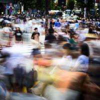Pedestrians on a busy intersection in Tokyo Tales from the cracks: 10 of the best books about Japan released in 2016