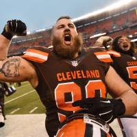 Browns defensive end Jamie Meder (left) and nose tackle Danny Shelton celebrate after their win over the Chargers on Saturday in Cleveland. The Browns avoided a winless season and improved to 1-14. Emotional Browns win to avoid 0-16 year