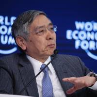 Bank of Japan Gov. Haruhiko Kuroda speaks during a plenary session at the World Economic Forum in Davos, Switzerland, on Friday. Davos conferees look to embrace windfalls from populist political shift, for now