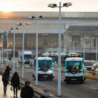 Two self-driving buses, produced by Easymile company, shuttle between Austrelitz station and Lyon stations in Paris, on Monday. Smog-hit Paris tests electric driverless minibus, color-codes car licenses