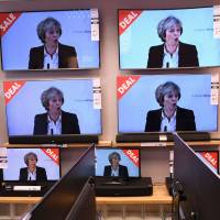 Televisions displayed at a store in Liverpool, northwest England, on Tuesday show a live speech by British Prime Minister Theresa May on the government’s plans for Brexit. Japan will push for best business outcome from Brexit, says Suga