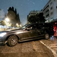 A hearse leaves a residence block where Russian Consul Andrey Malanin was found dead in his apartment in Athens Monday. Police investigating after key Russian diplomat, 55, found dead in his Athens flat