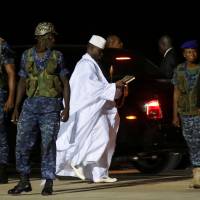 Security officers stand guard as former Gambian President Yahya Jammeh arrives at Banjul’s airport before flying into exile on Saturday night. African troops enter Gambia to secure Barrow's return after Jammeh stands down as president