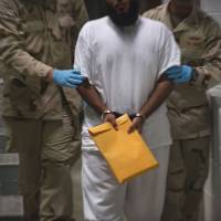 U.S military guards at Camp VI move a detainee back to his cell after he attended a life skills class at the U.S Detention Center in Guantanamo Bay, Cuba, in 2010. Oman takes in 10 inmates from Guantanamo