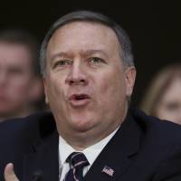 CIA Director-designate Rep. Michael Pompeo testifies on Capitol Hill in Washington,Thursday at his confirmation hearing before the Senate Intelligence Committee. Seated behind Pompeo is his wife, Susan Pompeo, and their son, Nick. CIA pick deviates from Trump, hits Russia meddlng, has intel ranks' 'backs'