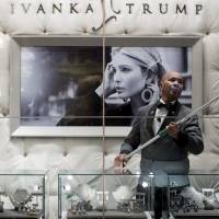 A worker cleans the windows of the Ivanka Trump Collection in the lobby of Trump Tower in New York on Tuesday. Trump retweets praise for his daughter, but tags the wrong Ivanka