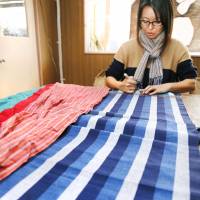 A woman makes a stole using Aizu cotton in Aizubange, Fukushima Prefecture. Fukushima entrepreneur revives famed Aoki cotton industry