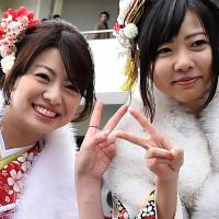 This picture taken Monday shows 20-year-olds flashing the “peace” sign, a common picture pose in Japan, while taking a photograph before their “Coming-of-Age” ceremony at the Tokyo Disneyland in Urayasu, Chiba Prefecture. Researchers warn of fingerprint theft from 'peace' sign
