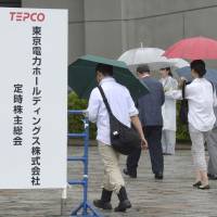 Investors enter a shareholders meeting for Tokyo Electric Power Company Holdings Inc. last June. Government taking aim at June bottleneck of shareholders meetings