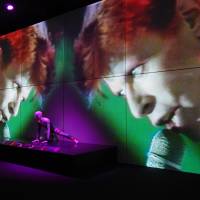 Space invader: An iconic knitted bodysuit designed by Kansai Yamamoto for David Bowie’s 1972-73 Aladdin Sane tour is lit by concert footage. The new testament to Bowie's star power
