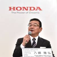 Honda Motor President, CEO and representative director Takahiro Hachigo (right) answers questions as Hitachi Automotive Systems President and CEO Hideki Seki listens during their joint news conference in Tokyo on Tuesday. Honda, Hitachi to partner on electric vehicles