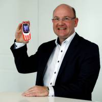 HMD Global President Florian Seiche poses for a photograph with the Nokia 3310 in London Friday. Nokia resurrects iconic 3310 mobile, with added features