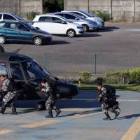 Military police soldiers board a helicopter, during a military police strike over wages, at Special Mission Battalion (BME) in Vitoria, Espirito Santo, Brazil, Sunday. Brazilian cops back on job after violent week of strikes; death toll at 137