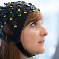 The NIRS/EEG brain-computer interface system is worn by a model in Switzerland in this undated photograph released in London Tuesday, Brain-computer interface lets paralyzed patients communicate thoughts