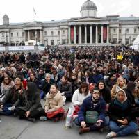 People watch Iranian director Asghar Farhadi’s film “The Salesman” on a huge screen set up in London’s Trafalgar Square on Sunday. After Trump ban, Iran director skips Oscars, shows 'The Salesman' film in London