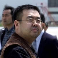 Kim Jong Nam exits a police van to board a plane to Beijing at Narita airport after being caught using a false passport while trying to go to Tokyo Disneyland in 2001. Malaysia says lethal nerve agent killed Kim Jong Nam