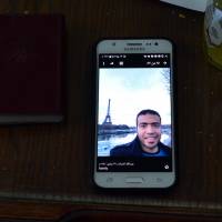 A picture taken on Sunday shows a picture of Abdallah El-Hamahmy, an Egyptian suspected of being the machete attacker in Paris’s Louvre museum, displayed on a phone at the family home in the Nile delta city of Mansura, some 120 km north of Cairo. Abdallah’s father said his son showed no sign of radicalization and he believed in his innocence. Louvre attacker identified as Dubai resident