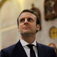 Emmanuel Macron, head of the political movement En Marche!, or Onwards!, and candidate for the 2017 French presidential elections, visits the Basilique Notre Dame d’Afrique in Algiers Tuesday. Kremlin denies meddling in French election, targeting top candidate Macron with 'fake news'