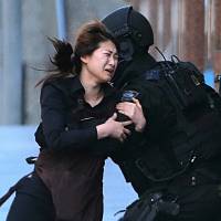 A hostage runs to tactical response police officers after escaping from a cafe during a siege in Sydney on Dec. 15, 2014. Despite Trump's claim, 'underreported' terrorist attacks on White House list were actually widely reported