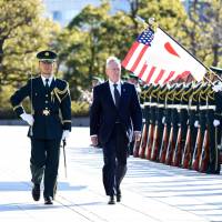 U.S. Defense Secretary James Mattis reviews an honor guard during the welcoming ceremony at the Defense Ministry in Tokyo on Saturday. Mattis clarifies U.S. defense pledge, stays mum on host-nation support