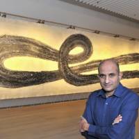 N.S. Harsha with his work “Again Birth — Again Death” (“Punarapi Jananam Punarapi Maranam,” 2013). Big impressions live in the details