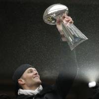Patriots quarterback Tom Brady lifts the Vince Lombardi Trophy during the team’s victory celebration on Tuesday in Boston. Brady rebuffs Gisele's call to retire