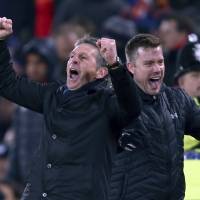 Southampton manager Claude Puel (left) celebrates a goal against Liverpool in their League Cup semifinal second leg at Anfield on Jan. 25. Model club Southampton hoping to claim silverware