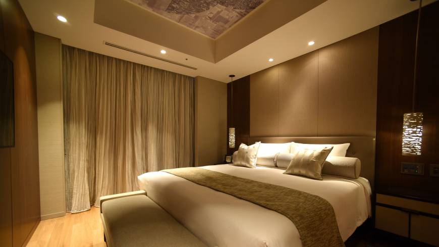 Guests can refresh themselves in a sedately decorated bedroom.