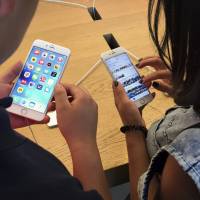 Customers try out Apple iPhone 6s models on display at an Apple Store in Beijing last year. New documents from WikiLeaks, posted Thursday, point to an apparent CIA program to hack Apple’s iPhones and Mac computers such that the exploits persist even after the devices are reset to factory conditions. Security experts say the exploits are plausible, but they are playing down the threat to typical users. CIA hacked Apple devices in ways users can't fix: WikiLeaks