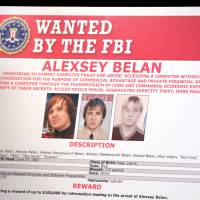 A poster of suspected Russian hackers is seen before the FBI National Security Division and the U.S. Attorney’s Office for the Northern District of California joint news conference at the Justice Department in Washington Wednesday. U.S. charges two Russian spies, hacking pair over massive Yahoo cyberattack