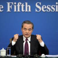 Chinese Foreign Minister Wang Yi gestures during a news conference on the sidelines of the National People’s Congress in Beijing on Wednesday. China says first draft of South China Sea code of conduct ready