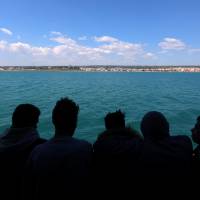 Migrants have a first glimpse of Europe aboard the former fishing trawler Golfo Azzurro, two days after they were rescued by the Spanish NGO Proactiva Open Arms in the central Mediterranean Sea, as they arrive at the port of Pozzallo in Sicily Thursday. Rare happy ending: Gambian survivor unaware 140 fellow migrants rescued in Mediterranean