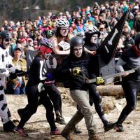 A coffin race team carries a woman in a casket on Saturday at the Frozen Dead Guy Days festival in Nederland, Colorado. Sleepy Colorado town comes alive for Frozen Dead Guy Days
