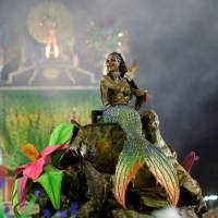 A reveler from the Portela samba school performs during the second night of the carnival parade at the Sambadrome in Rio de Janeiro on Tuesday. Rio Carnival crowns champion after accident-marred festivities